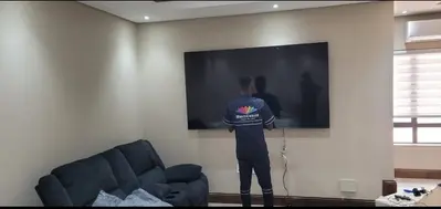 MultiChoice technician professionally mounting large TV